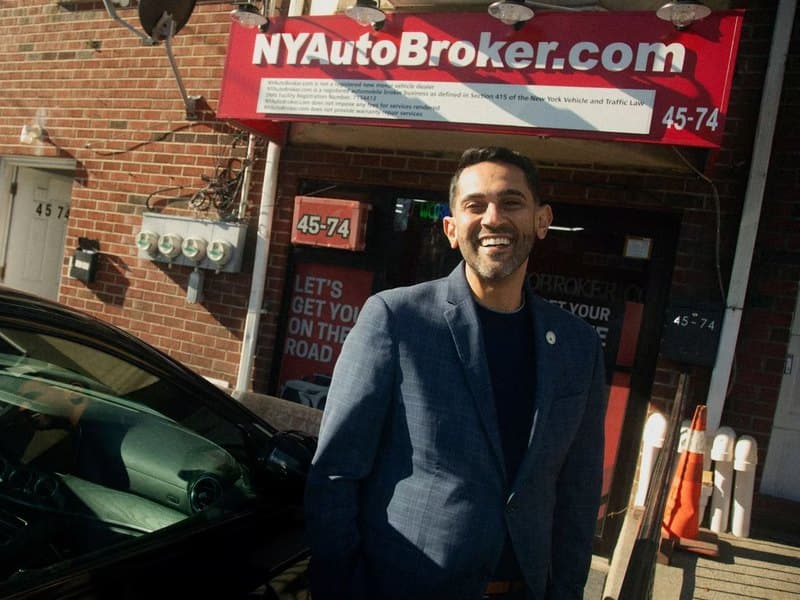 The owner of NY Auto Broker outside his showroom