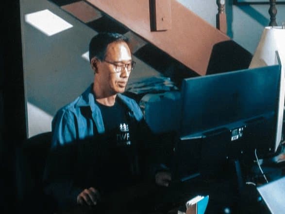 A TWFG Insurance agent working at his desk under the stairs
